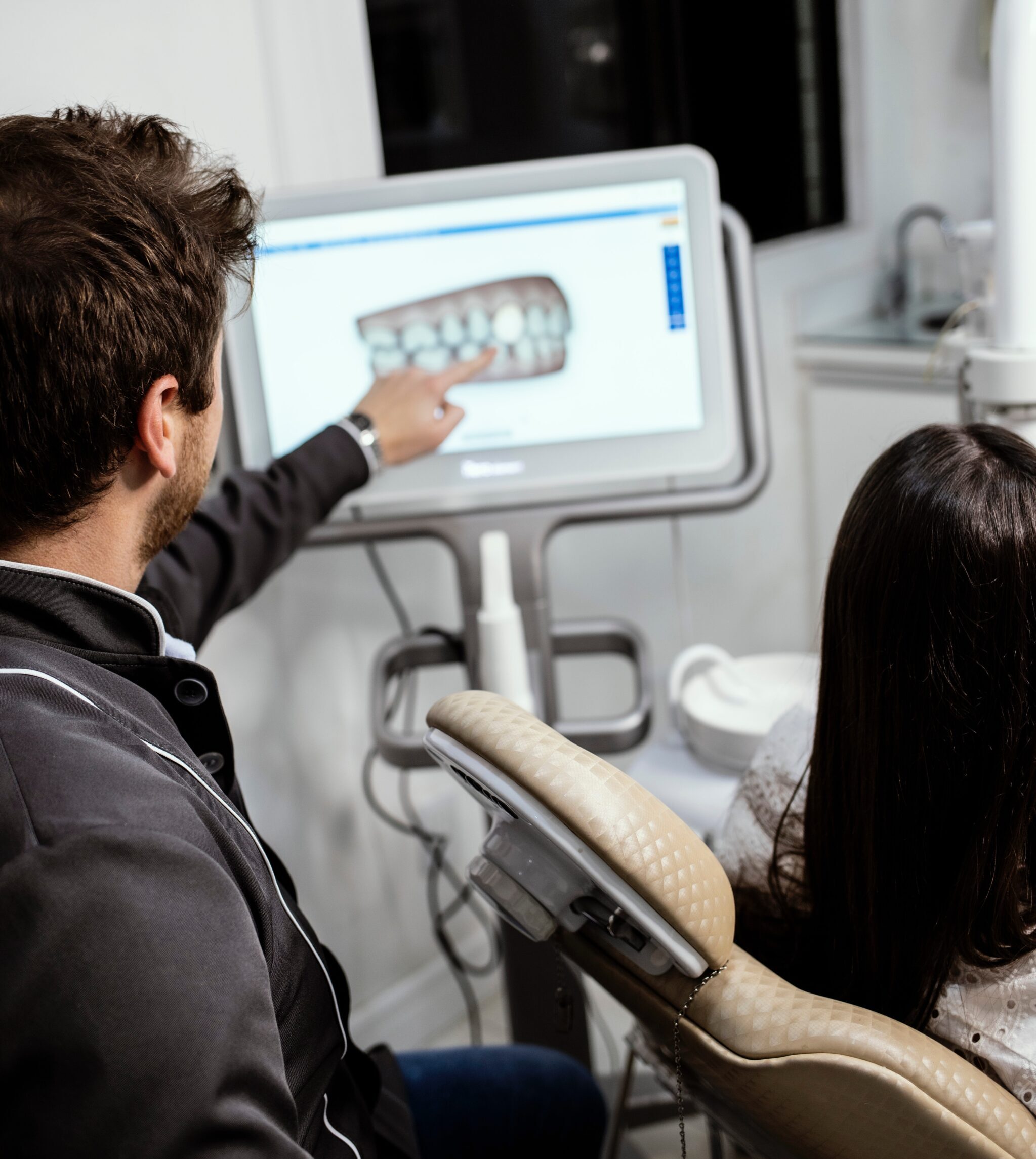 Dental professional looking at x-ray